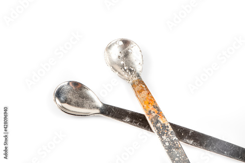 Damaged with oxidation metal laboratory spoon, spatula isolated on white background. Metal Laboratory Equipments. Lab spatulas reagent lab sampling used in laboratory. photo