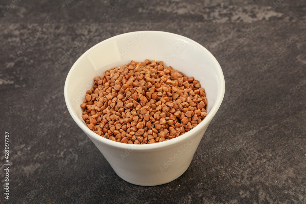 Raw buсkwheat cereal in the bowl Raw buсkwheat cereal in the bowl