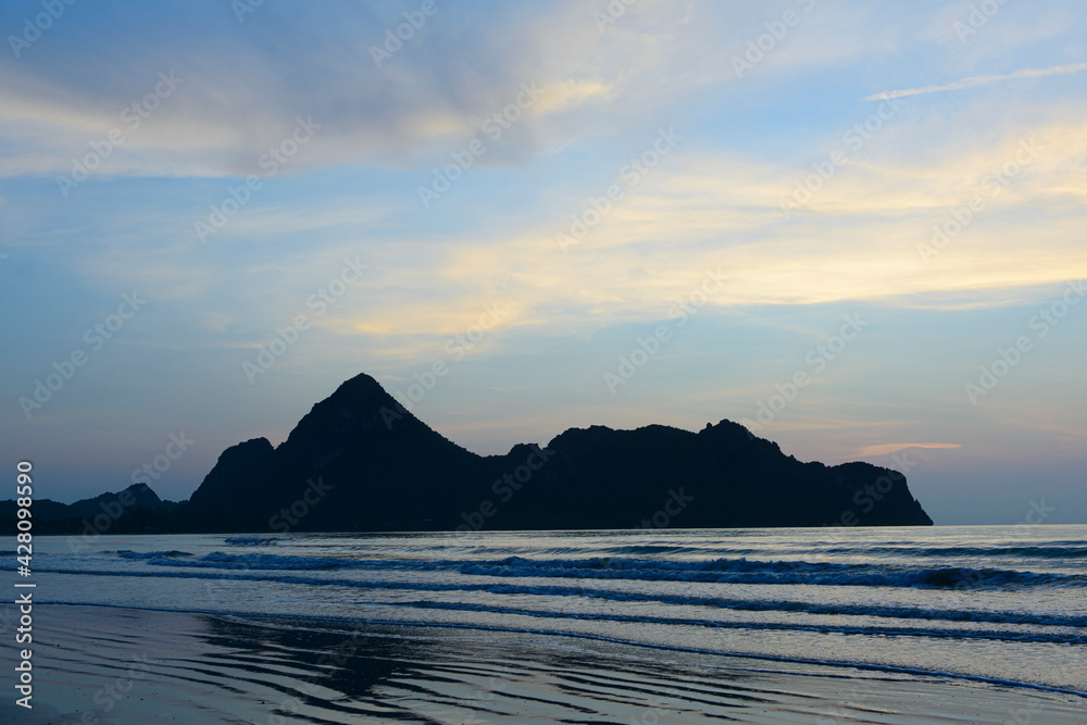 Fototapeta premium Dramatic sunset over mountain and sea.