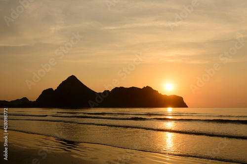 Dramatic sunset over mountain and sea.