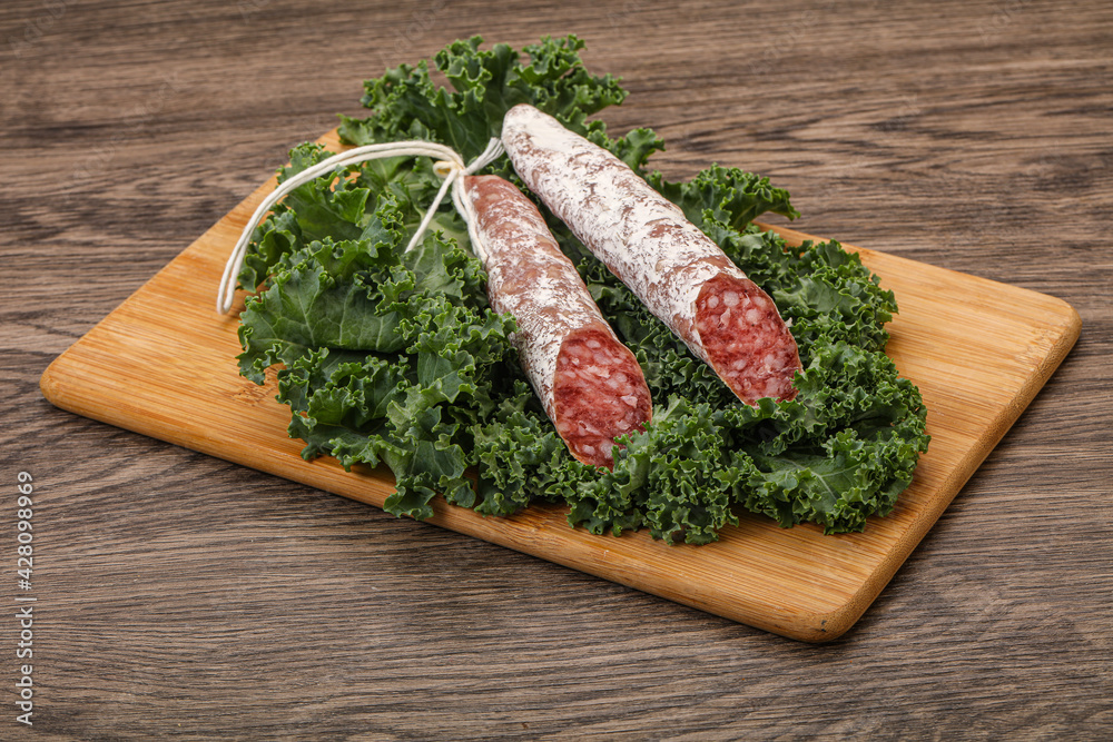 Spanish Fuet sausage with salad leaves