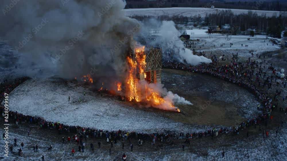 Great wood building on fire from the drone view. Spring aerial flight around massive wood structure in flames. High quality 4k footage