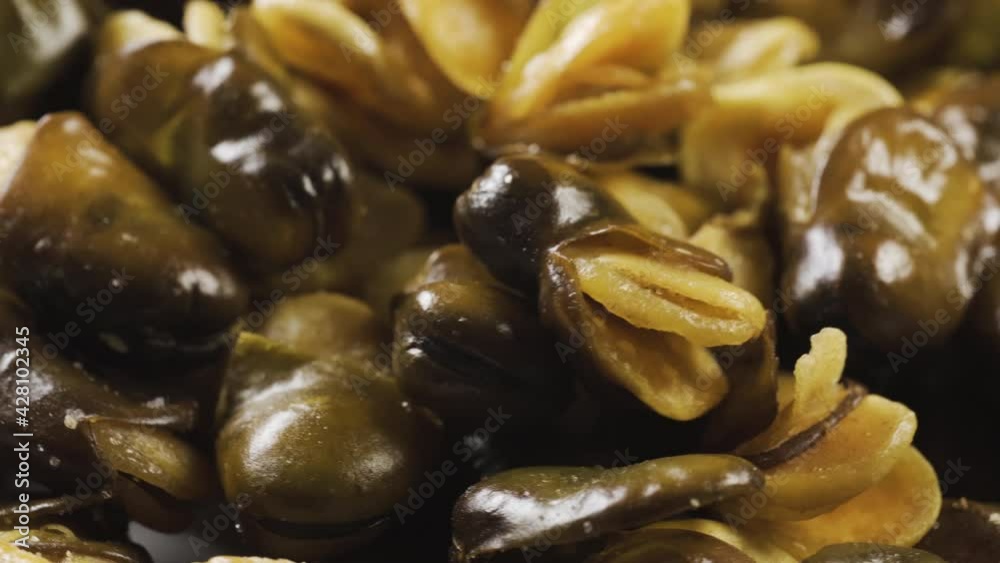 Fried broad bean on a rotating table. Snack food macro shot. Slowly spin around in pattern.