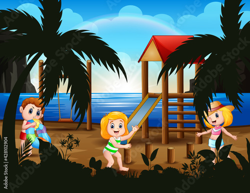 Happy kids playing in playground near the beach
