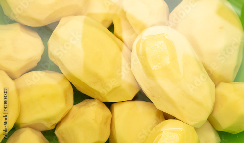 Peeled potatoes in water as a background.
