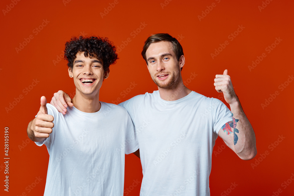 two man in white t-shirts fun emotions hand gestures friendship hugs two man in white t-shirts fun emotions hand gestures friendship hugs