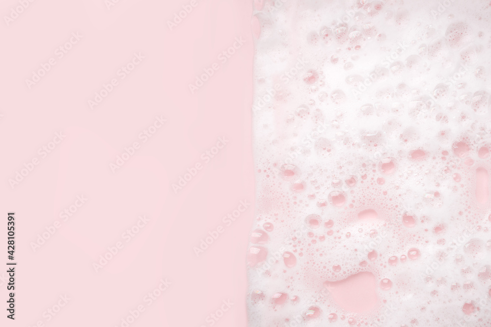 White foam bubbles texture on pink pastel background, copy space, banner for loundry, cleaning service, bathroom concept, clean, wash - liquid soap, shower gel, shampoo