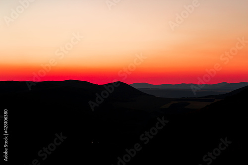Red sunset with mountain silhouette. Scenery with mointains in sunset.