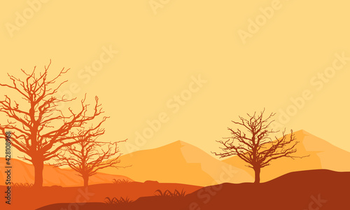 An amazing view of the mountains from the outskirts of the city at dusk with the silhouettes of dry trees around them. Vector illustration