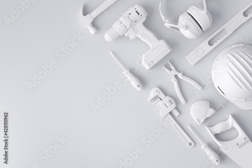 Top view of monochrome construction tools for repair and installation on white