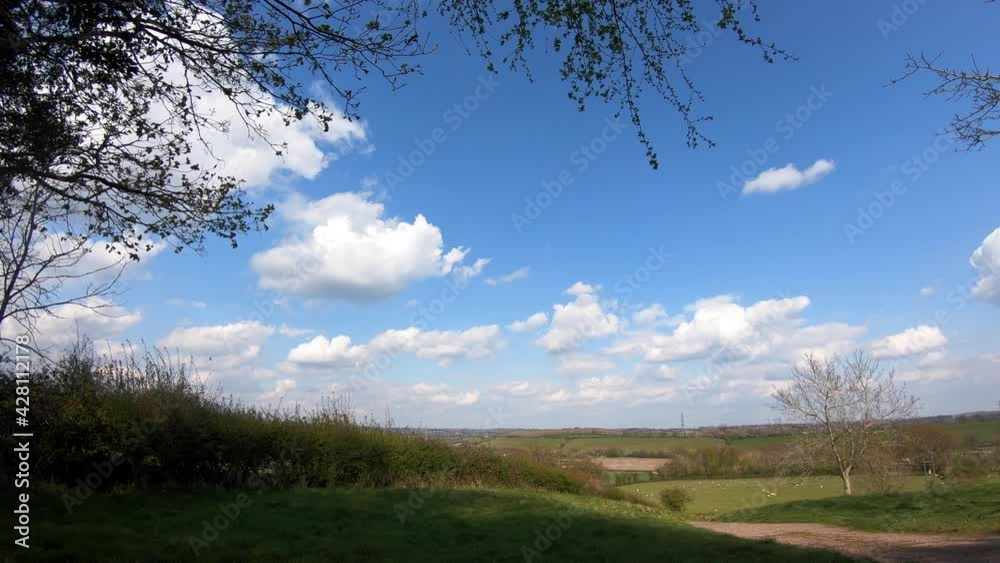 A bright Spring day in the Worcestershire countryside, UK as white fluffy clouds speed by in a time lapse A bright Spring day in the Worcestershire countryside, UK as white fluffy clouds speed by in a time lapse