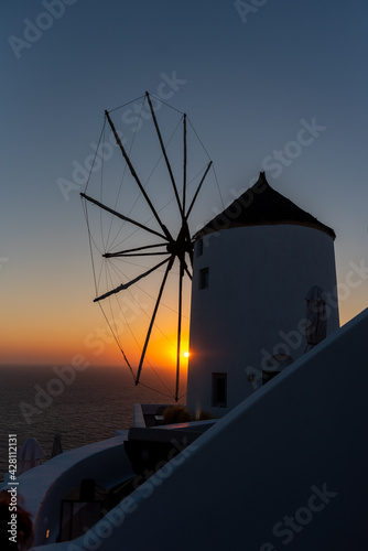 Traditional Santorini windmill at sunset. 