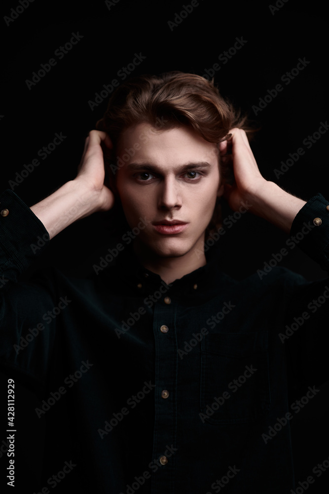 guy poses on black background
