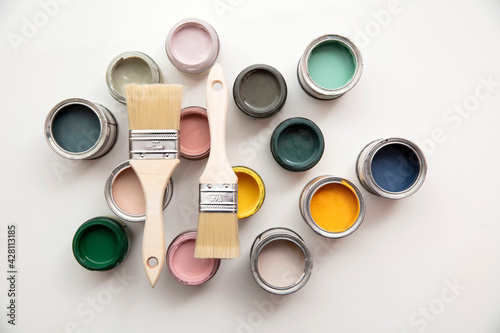Overhead view of a DIY paint brush with colorful sample paint pots