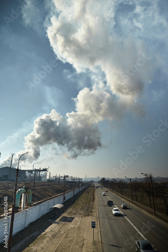 Large industrial metallurgical and chemical plant in Mariupol, Ukraine. Factory pollutes environment. Ecology disaster. Toxic enterprise chimneys tubing against the sky background release smoke