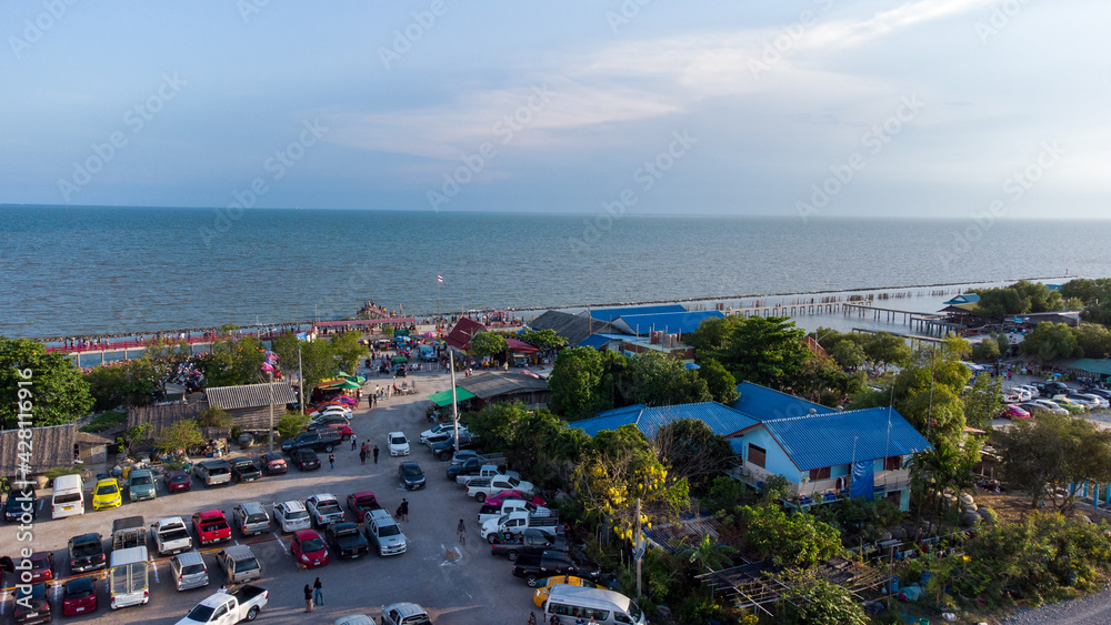 Photo from drone on car park of wooden red long bridge at seaside of samut sakhon province,Thailand.