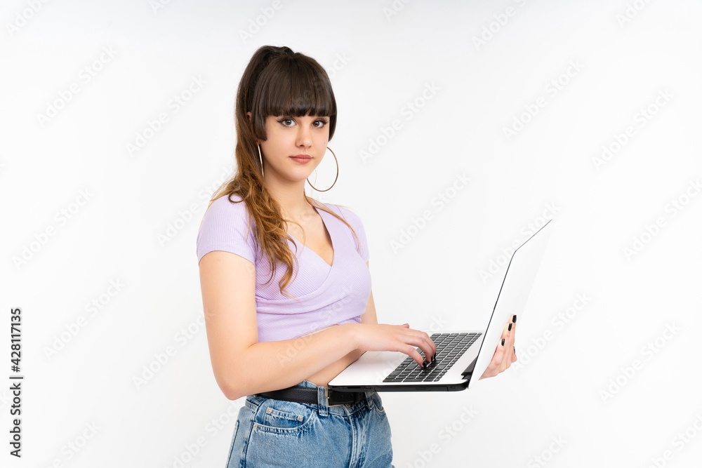 Naklejka premium Woman with laptop on command typing on white background looking at camera.