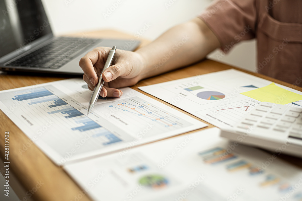 Finance employees are reviewing the financial information on documents that were prepared before sending them to management for a meeting with shareholders. Financial concept. Finance employees are reviewing the financial information on documents that were prepared before sending them to management for a meeting with shareholders. Financial concept.