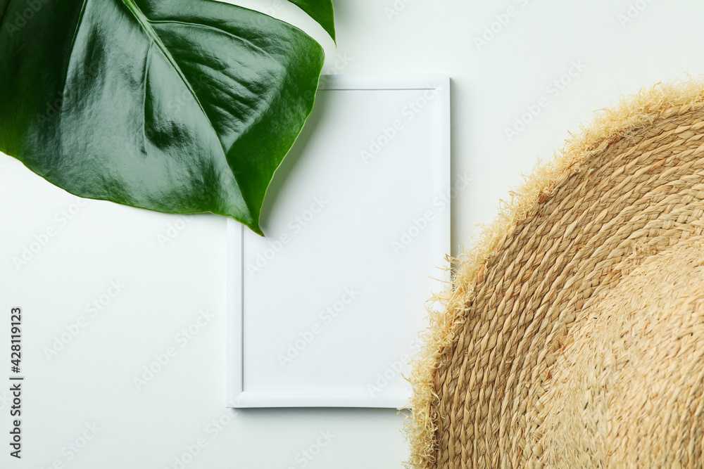 Straw hat, palm leaf and empty frame on white background Stock Photo ...