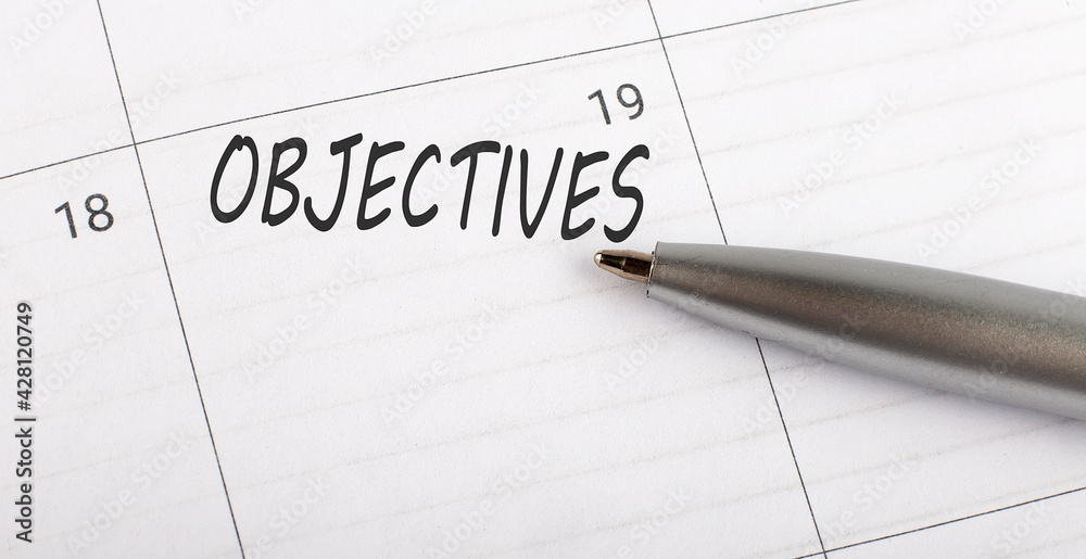 Text Objectives written on a calendar planner to remind you an important appointment with a pen on isolated white background. Text Objectives written on a calendar planner to remind you an important appointment with a pen on isolated white background.