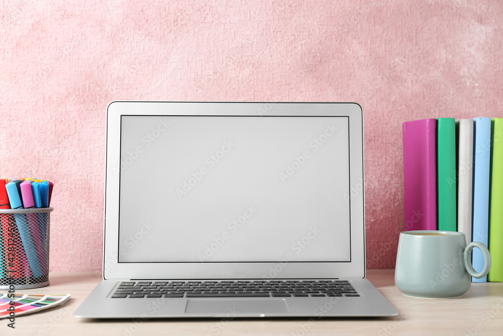 Fototapeta premium Modern laptop and cup of coffee on white table. Space for design