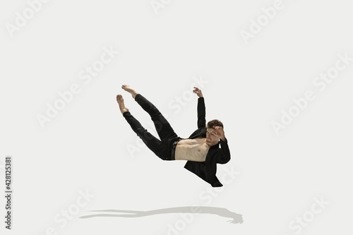 Картината върху платно Man in casual style clothes jumping and dancing isolated on white background