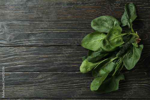 Fresh raw spinach on rustic wooden background