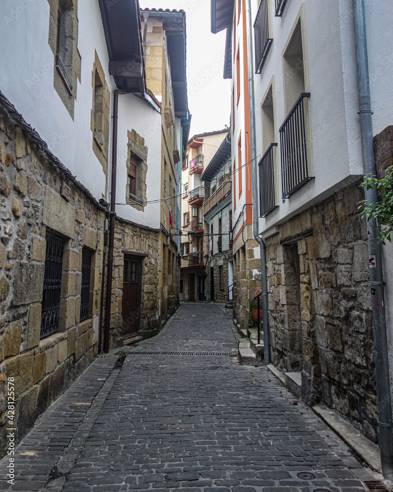 San Sebastian, Spain - March 1, 2021: Narrow cobblestone streets in the historic fishing village of Pasaia San Juan