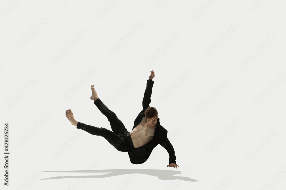 Man in casual style clothes jumping and dancing isolated on white background. Art, motion, action, flexibility, inspiration concept. Flexible caucasian ballet dancer. Man in casual style clothes jumping and dancing isolated on white background. Art, motion, action, flexibility, inspiration concept. Flexible caucasian ballet dancer.