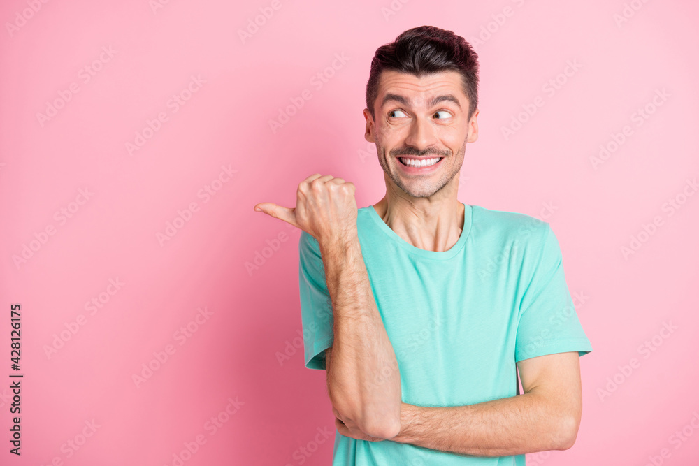 Photo of young excited man happy smile indicate finger empty space select advice ad isolated over pink color background