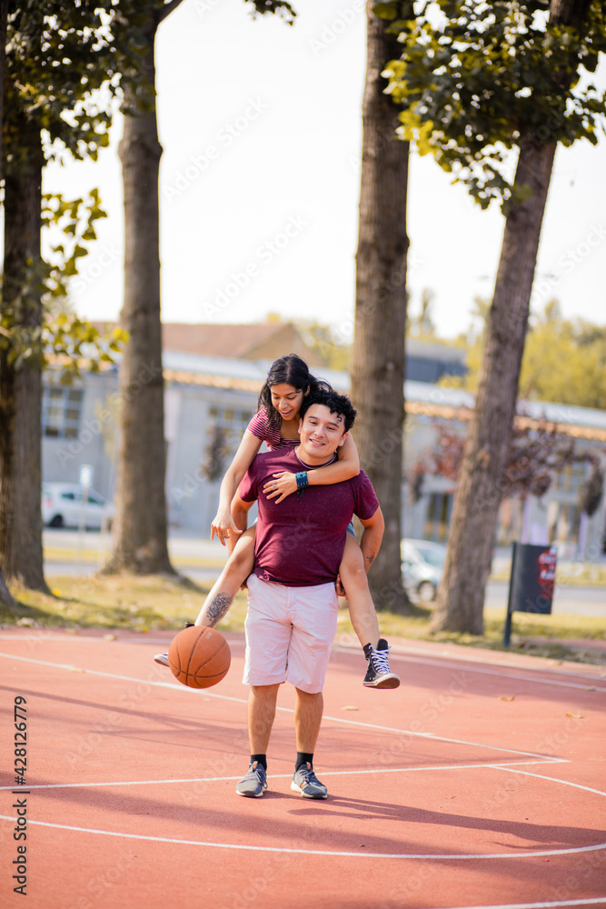 Young couple playing basketball.