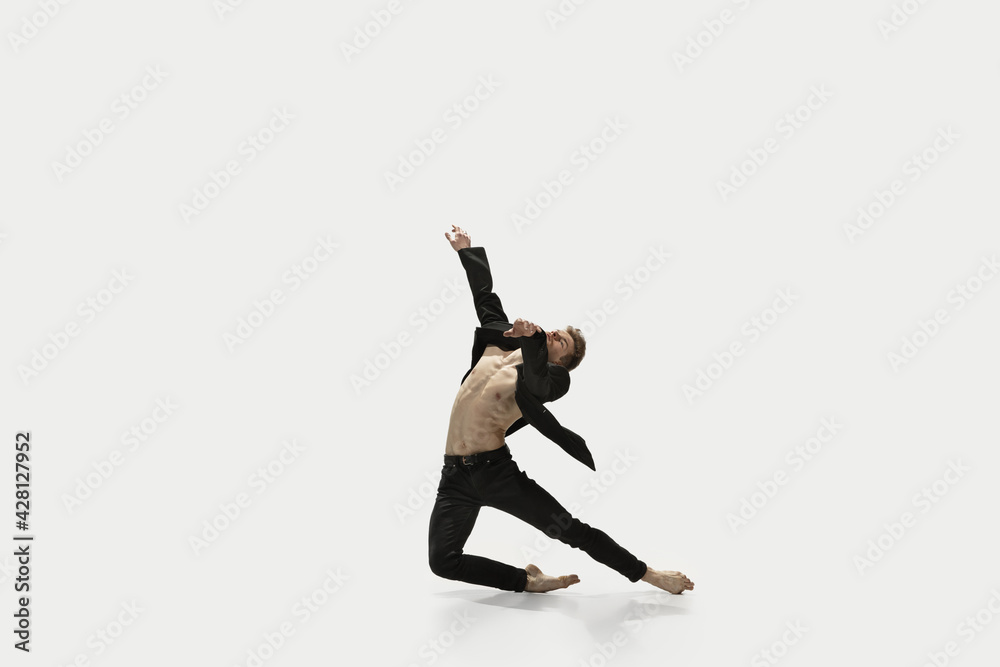 Man in casual style clothes jumping and dancing isolated on white background. Art, motion, action, flexibility, inspiration concept. Flexible caucasian ballet dancer.