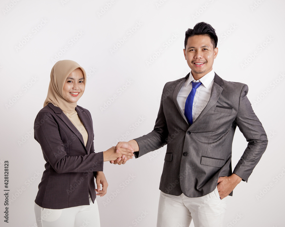 two young couples business smiling handshake working looking at the camera isolated white background two young couples business smiling handshake working looking at the camera isolated white background