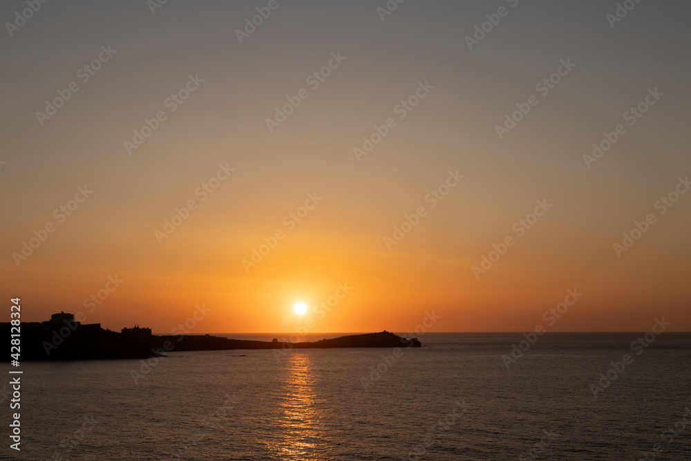 Sunset over Town Head, Newquay, Cornwall with the Headland Hotel silhouetted on the headland Sunset over Town Head, Newquay, Cornwall with the Headland Hotel silhouetted on the headland