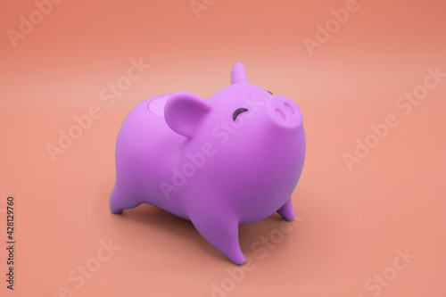 Piggy bank on orange background. Finance, saving money concept.