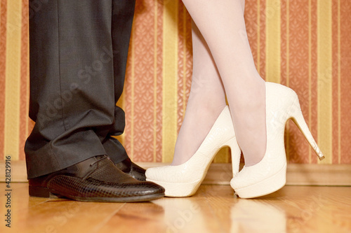 Legs of a guy and a girl in shoes close-up