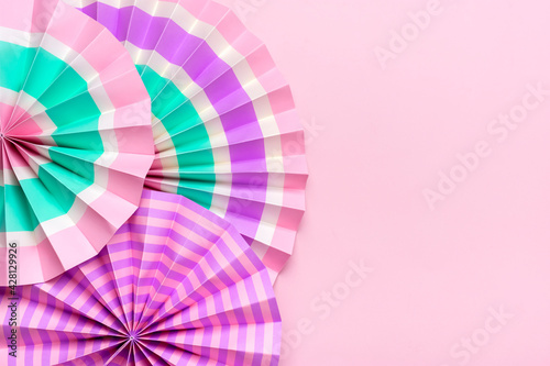 Traditional Japaneses festival paper fan with pink, turquoise, white stripes Birthday party, celebration holidays concept Abstract background Wall decor Banner