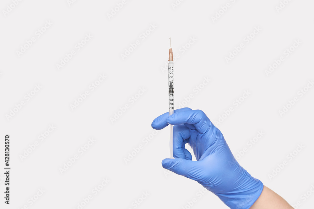 Person in blue glove hold vaccine bottle with syringe. Injection pharmacy concept. Medical nurse therapy. People hand health science. Horizontal banner Person in blue glove hold vaccine bottle with syringe. Injection pharmacy concept. Medical nurse therapy. People hand health science. Horizontal banner