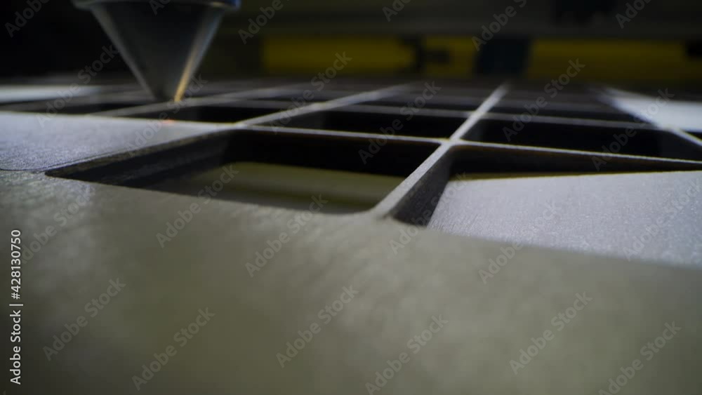 Automatic wooden jigsaw puzzle production on toys factory. 4k macro hdr footage of cutting plywood with laser ray. Wooden toys design concept Automatic wooden jigsaw puzzle production on toys factory. 4k macro hdr footage of cutting plywood with laser ray. Wooden toys design concept