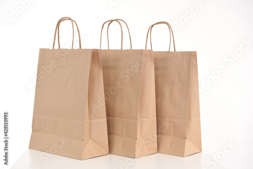 Three eco friendly paper bags for gifts or packaging on a white background