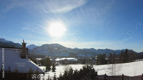 Time lapse of view through balcony over mountains in Zakopane. Poland during sunny day in winter.
