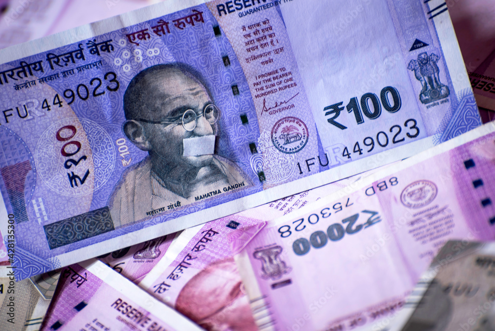 Fototapeta premium Close-up of one hundred Indian rupees against Indian paper currency background