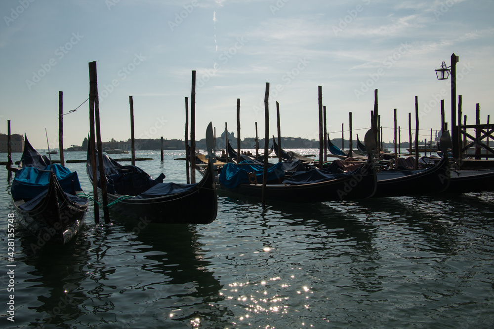 góndolas flotando en canal veneciano al atardecer