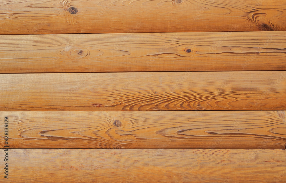 Brown textured background with logs. Wall of log in orange color at home. Wooden logs as rural wallpaper with copy space for text. Pine tree textured board in natural color with paneling view. Brown textured background with logs. Wall of log in orange color at home. Wooden logs as rural wallpaper with copy space for text. Pine tree textured board in natural color with paneling view.