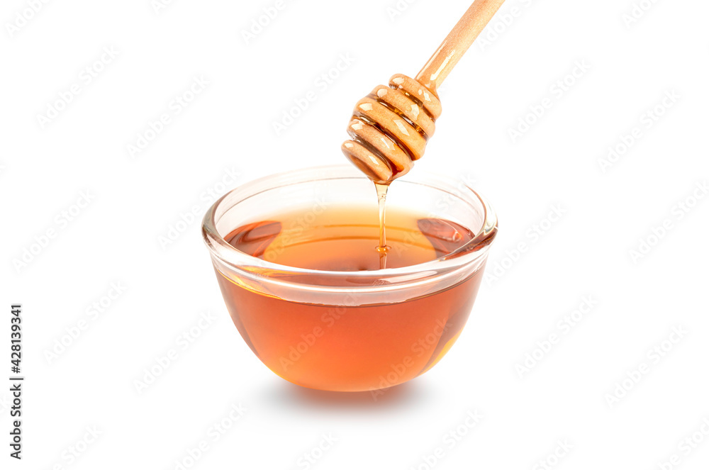 Honey in glass bowl with dipper isolated on white background. Honey in glass bowl with dipper isolated on white background.