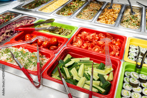 Serving vegetables and salads, self-service restaurant. vegetables tomatoes, cucumbers, marinade. Copispace photo