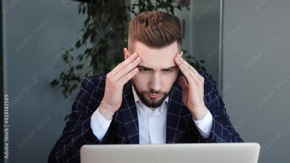Stressed business man with beard suffering from muscles tension, having painful head feelings due to computer overwork or sedentary working lifestyle. Tired employee overwhelmed with tasks in office Stressed business man with beard suffering from muscles tension, having painful head feelings due to computer overwork or sedentary working lifestyle. Tired employee overwhelmed with tasks in office
