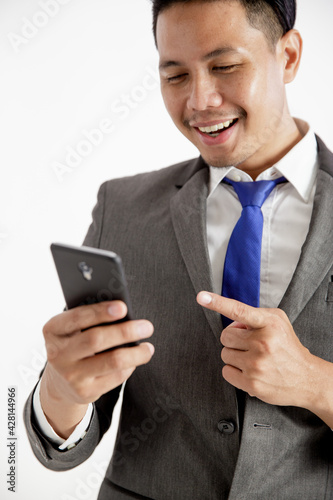 portrait young man entrepreneur excited holding phone office work concept looking at the phone isolated white background