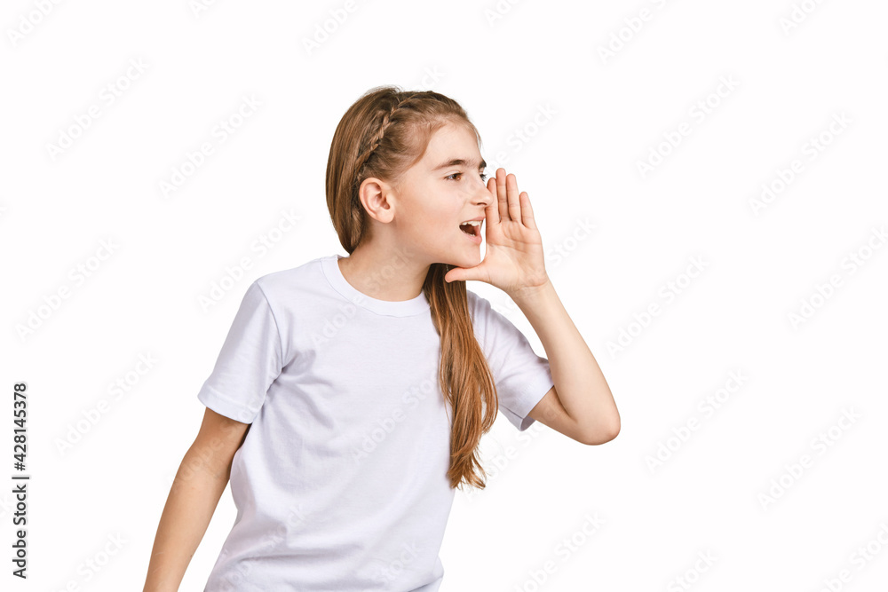 Children portrait in white t-shirt. Studio isolated concept. Shout rumor. Secret gossip. Modern communication. Girl hold hand near head Children portrait in white t-shirt. Studio isolated concept. Shout rumor. Secret gossip. Modern communication. Girl hold hand near head