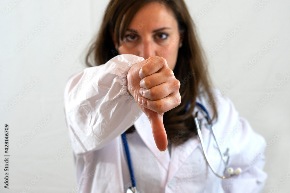 © fabio - Female doctor shows thumbs down. Concept of unhealthy habit.
